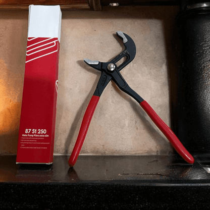 Water Pump Pliers with ergonomic handles displayed alongside packaging on a countertop.